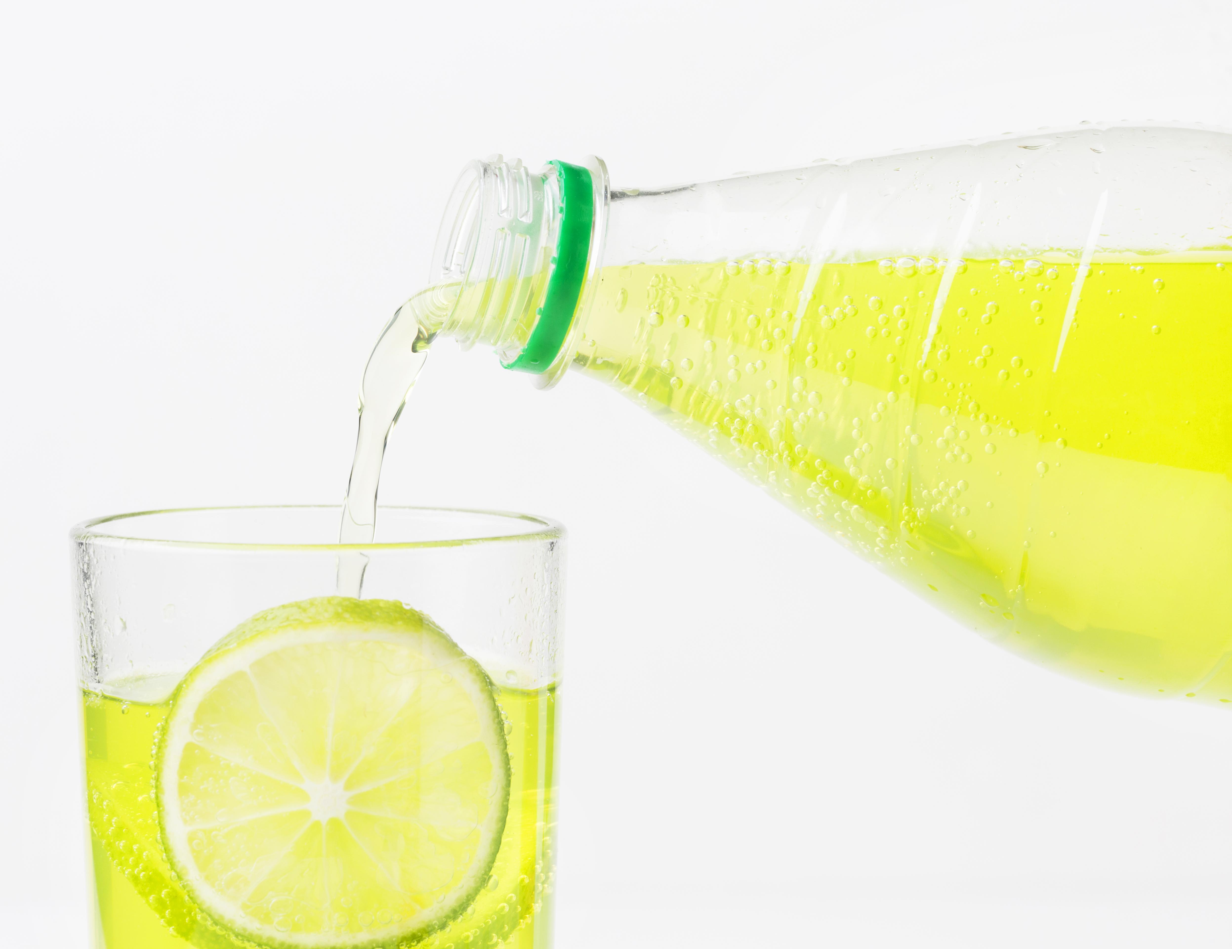 soft-drink-being-poured-into-glass-with-lime.jpg